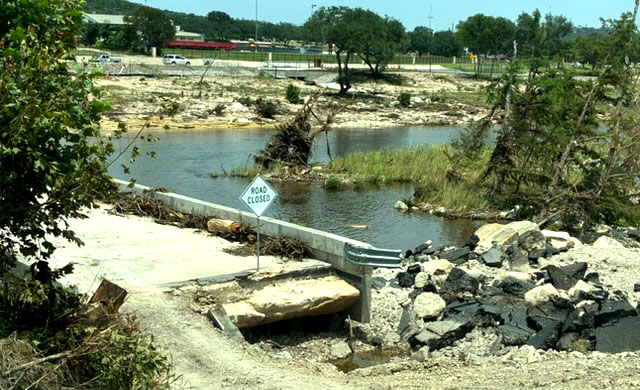 An image shows huge pieces of roadway missing on one end of Cade Loop Bridge.